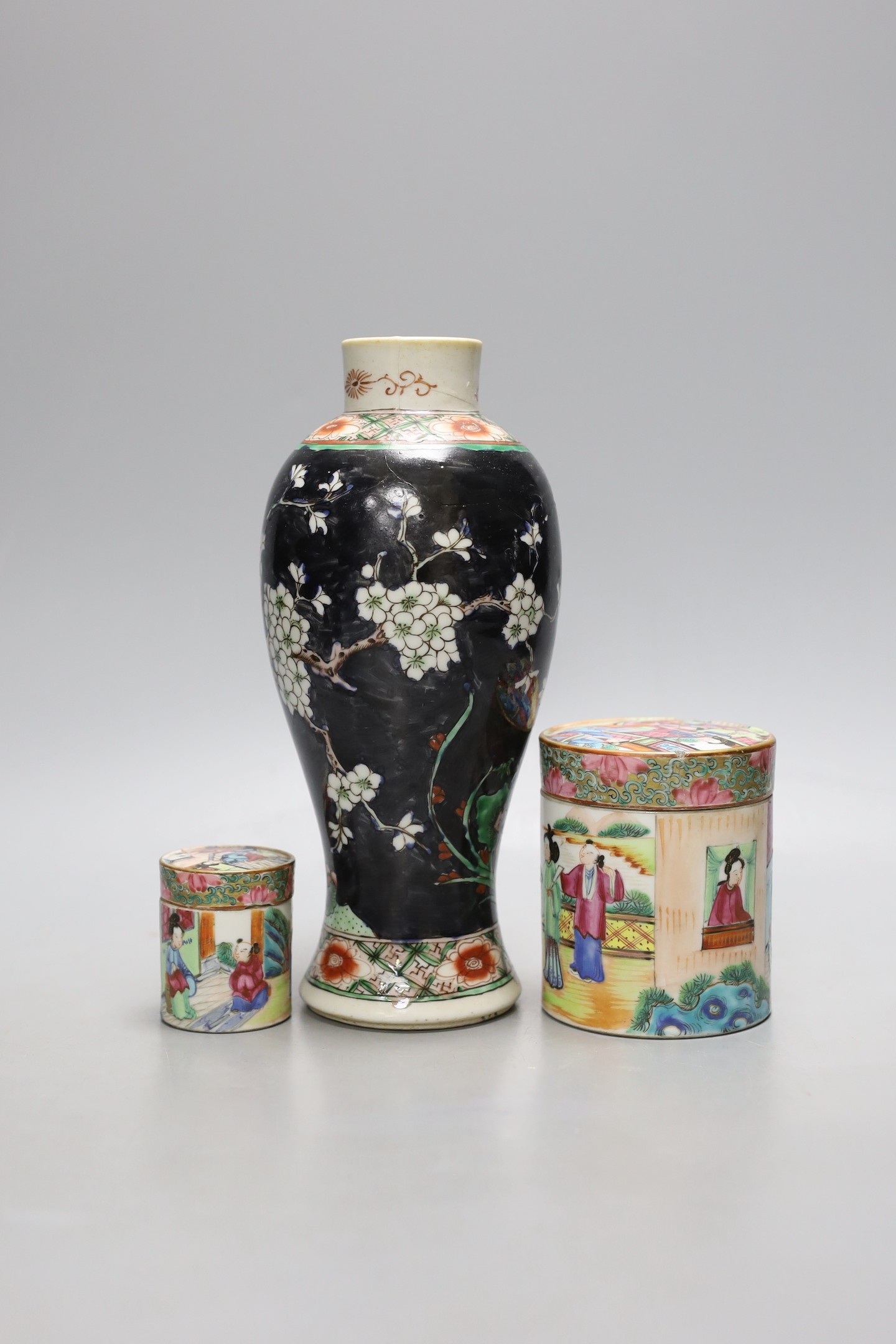 A Chinese famille noire vase, and two famille rose lidded pots, 19th century, Vase 12 cms high.